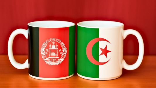 Afghanistan and Algeria country flag mugs displayed next to each other on a table with a blurry background