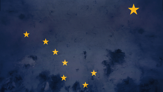 A painted Alaska flag. Clearly showing the blue background with the yellow stars.