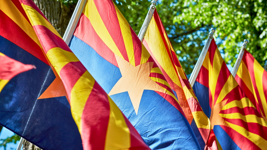 A close-up of a row of hanging Arizona State Flags