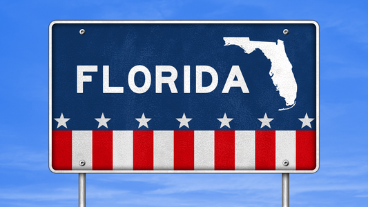 Florida State Sign Board on the side of the road with a map of Florida and an US flag design