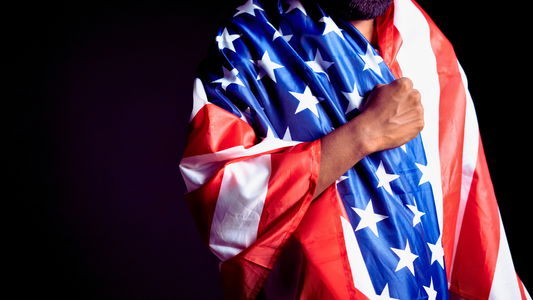 Man with US flag draped over his shoulders