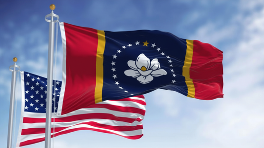 Mississippi State flag flying high next to the US flag with a wonderful blue sky in the background