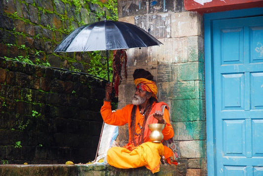 Nepal Guru sitting in front of wall