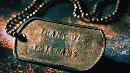 Close-up of dog tags with the words "Thank you veterans" etched in them.