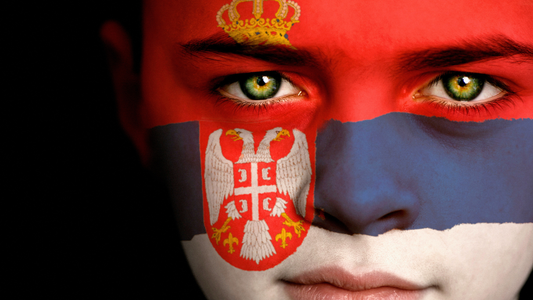 Close-up of the face of a woman who's face is painted with the Siberian Flag